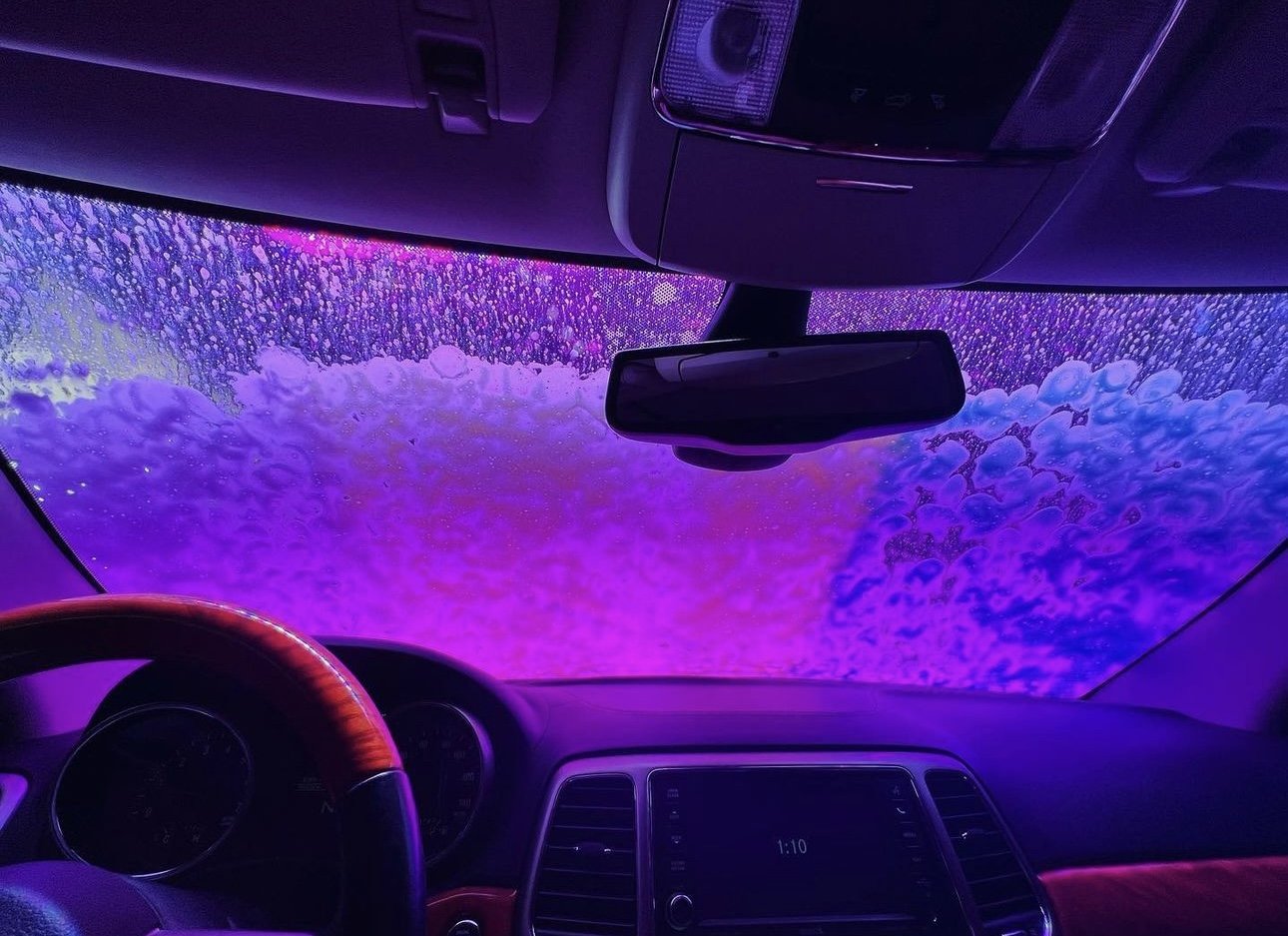 A windshield covered in purple wash foam inside Turbo Jet
